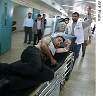 An injured man is wheeled into a hospital in Gaza City following factional clashes, 15 May 2007