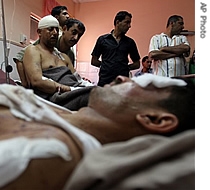 Injured Iraqis from the village of Abu Saydah in the volatile Diyala province lie at hospital beds in in Sadr City Shiite district in Baghdad, Iraq, 16 May 2007