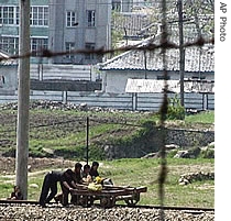 North Korean workers repair railroad tracks near the Kumgangsan Youth railway station at the Diamond Mountain resort in North Korea, 14 May 2007