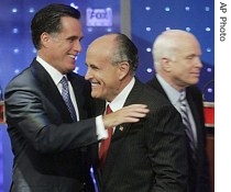 Republican presidential hopefuls former Massachusetts Governor Mitt Romney, left, embraces former New York City Mayor Rudy Giuliani, as Senator John McCain walks by after the Republican debate, 15 May 2007