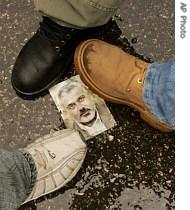 Palestinian men step on a picture of Palestinian PM Ismail Haniyeh as a protest against the Hamas-Fatah factional fighting, 16 May 2007