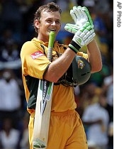 Australia's batsman Adam Gilchrist celebrates as he points to his left hand glove during the Cricket World Cup final against Sri Lanka in this 28 April 2007 file photo