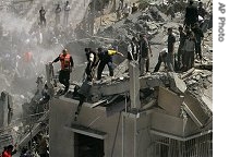 Palestinians search the rubble of a building after an Israeli air strike on the facility used by the Islamic group Hamas in Gaza City, 17 May 2007