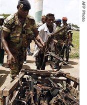 An Ivorian troop gathers guns handed back by West Resistance Armed Forces (FRGO)'s members during a ceremony for the dismantling of militias