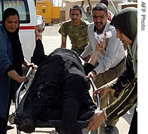 A wounded Iraqi woman is wheeled into a hospital in Baquba, capital of the violent province of Diyala, 21 May 2007