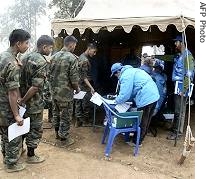 Members of a UN monitoring team observe as Maoist fighters register themselves, during a weapons and personnel registration function, at a camp in Chitwan (File)