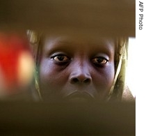 A displaced Sudanese woman is seen outside her barrack at the Sakali Displaced Persons camp in Darfur
