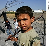 Palestinian children walk amid the rubble of a house, destroyed following an Israeli air strike, in the Jabalia refugee camp in the Gaza Strip, 23 May 2007