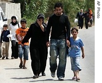 Palestinians flee from the Palestinian refugee camp of Nahr el-Bared, in the north city of Tripoli, Lebanon, 23 May 2007