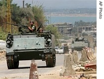Two Lebanese army vehicles patrol the entrance of the Palestinian refugee camp of Nahr el-Bared in the northern city of Tripoli, Lebanon, 22 May 2007