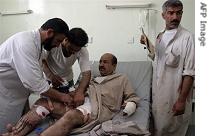 A wounded man is treated at a hospital after a car exploded at the funeral of the murdered nephew of a local tribal leader in the western Iraqi city of Fallujah, 24 May 2007