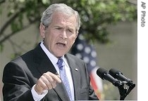 President Bush gestures during a news conference in the Rose Garden of White House, 24 May 2007