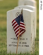A flag placed by a Boy Scout sits in front of a World War II soldier's head stone at Long Island National Cemetery in Farmingdale, New York, 26 May 2007