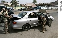 Iraqi soldiers search a car in Baghdad, 30 May 2007