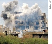 An explosion strikes a building in Nahr el-Bared refugee camp near Tripoli, Lebanon, 2 June 2007