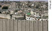 Palestinian refugee camp of Kalandia is seen behind section of Israel's separation barrier near West Bank city of Ramallah, 04 Jun 2007