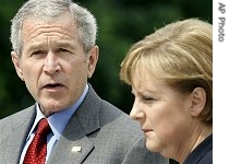 President Bush, left, accompanied by German Chancellor Angela Merkel, makes remarks to reporters after their meeting at&nbsp; start of G8 Summit in Heiligendamm, Germany 06 Jun 6 