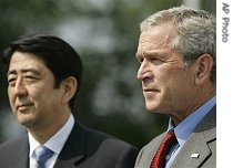 U.S. President Bush (r)accompanied by Japanese Prime Minister Shinzo Abe, make remarks after their meeting at the start of the G8 Summit in Heiligendamm, Germany, 06 Jun 2007