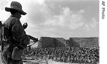 Egyptian prisoners are guarded by Israeli troops after being captured near Al Arish in the Sinai during the Six Day War, June 1967