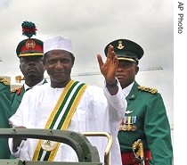 Umaru Yar'Adua, 56, waves to supporters after he is sworn in in Abuja, 29 May 2007