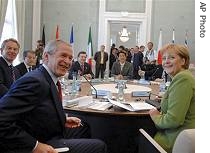 German Chancellor Angela Merkel, left, gestures as she turns around next to US President George Bush during the second workig meeting at the G8 Summit in Heiligendamm, 07 Jun 2007