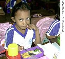 Jakarta elementary school student sits down to an iron and<br />vitamin-rich meal as part of a weekly nutrition education program 
