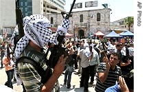 Palestinians react as members of the Al Aqsa Martyrs Brigades fire weapons, 13 Jun 2007