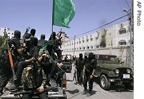 Hamas militants ride in a truck outside the Preventive Security headquarters after it was captured in Gaza City, 14 Jun 2007