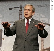 President Bush gestures to the crowd to be seated as he arrives to deliver remarks to the Associated Builders and Contractors in Washington, 14 June 2007