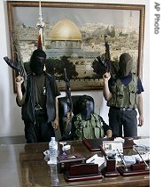 Hamas militants pose as they stand at the desk of Palestinian President Mahmoud Abbas in Gaza City, 15 Jun 2007