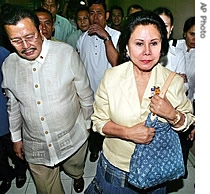 Ousted President Joseph Estrada, left, and his wife Senator Luisa Ejercito walk out of the anti-graft court together after hearing the closing arguments of his plunder case, 15 June 2007 in suburban Quezon City north of Manila