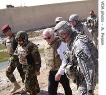 Iraqi and American officers escort Secretary Robert Gates, center, and Iraqi Staff Major General Riyadh Jalal Tawfiq at the Joint Security Station
