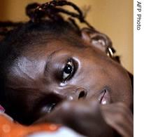 A young HIV-infected woman lying in an Abidjan hospital
