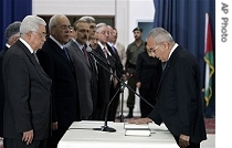 Palestinian President Mahmoud Abbas, left, looks at newly-appointed Palestinian Prime Minister Salam Fayad,  Ramallah, Sunday, 17 June 2007