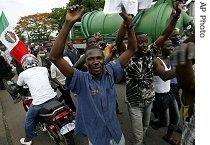 People walk past as they protest in the street against government price rises in Lagos, Nigeria, 20 Jun 2007