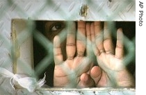 Guantanamo detainee peers out through the so-called 
