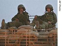 Israeli soldiers ride on the top of an armored vehicle towards the Gaza Strip on the border with Israel, 9 June 2007 (file photo)