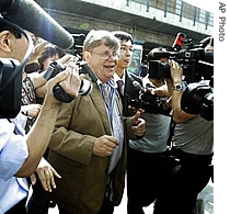 Olli Heinonen, the International Atomic Energy Agency's deputy director general for safeguards, center, talks to journalists after arriving the airport in Beijing, 25 June 2007