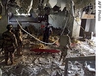 Iraqi soldiers inspect damage as bodies lay on the floor at the Mansour hotel in central Baghdad, 25 Jun 2007