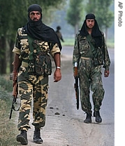 ndian paramilitary soldiers patrol near the site of an explosion in the outskirts of Srinagar, India, 24 June 2007