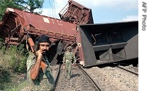 Central Reserve Police Force inspects site where goods train was blown up by land-mine near Chetar railway station in  Lathehar district, 26 Jun 2007