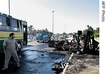 An Iraqi walks away from the site where a car Bomb and an improvised explosive device exploded simultaneously at Kahtan square in Baghdad's Yarmouk area (Sep 2006)