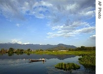 A Kashmiri boatman paddles his boat in marshland, once part of the famous Dal Lake, in Srinagar India, Wednesday, 7 June 2007