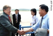 This 26 June 2007 picture, released from Korea Central News Agency 27 June, shows IAEA Deputy Director General Olli Heinonen (L) shaking hands with an unidentified North korean official upon his arrival at the Pyongyang Airport
