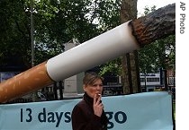 A cigarette billboard reminding people passing through London's Leicester Square, 19 Jun 2007, that a no smoking ban inside all public places in England starts July 1