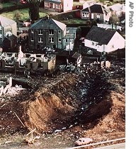 Wrecked houses and a deep gash in the ground in the village of Lockerbie, Scotland - damage caused by the crash of Pan Am Flight 103, 21 Dec 1988