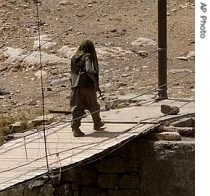 A local PKK military leader, walks over a bridge in Mezdori village in northern Iraq near the Iraqi-Turkish border, 7 June 2007