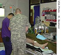 Dcotors at the Ibn Sina hospital work on a wounded patient