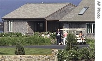 President Bush, center, chats with his mother, Barbara Bush, wearing hat, and others after arriving in Kennebunkport, Maine, 28 Jun 2007