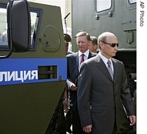 Russian President Vladimir Putin, right, wearing sunglasses and First Deputy Prime Minister Sergei Ivanov, background, visit a Command and Control Center in Rostov-on-Don, 29 June 2007
